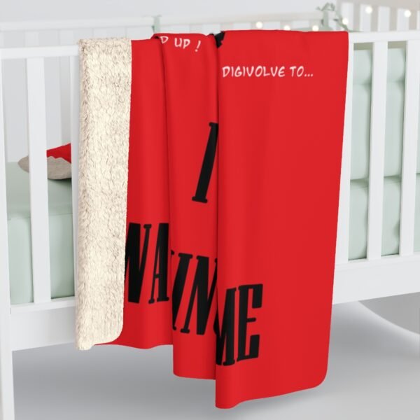Red blanket with text draped over crib