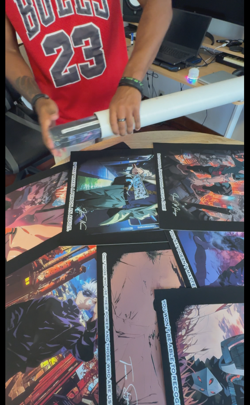 Person rolling posters on a table.